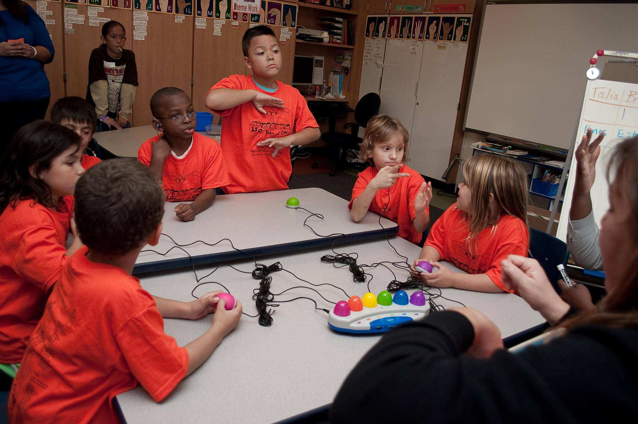 Deaf children in a circle at a table