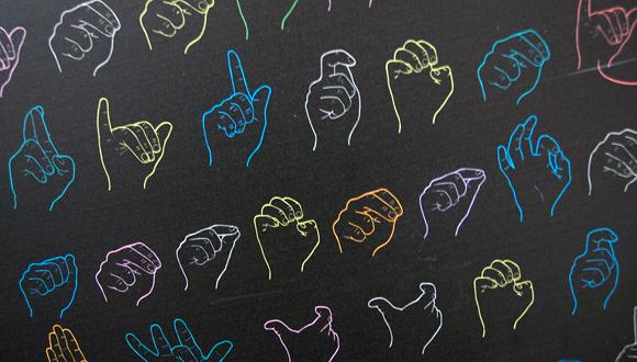 black background with outlines of hands fingerspelling